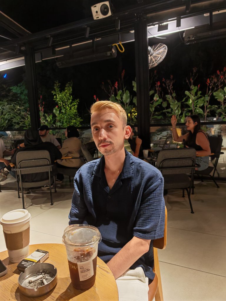 Night portrait at a cafe with iced coffee
