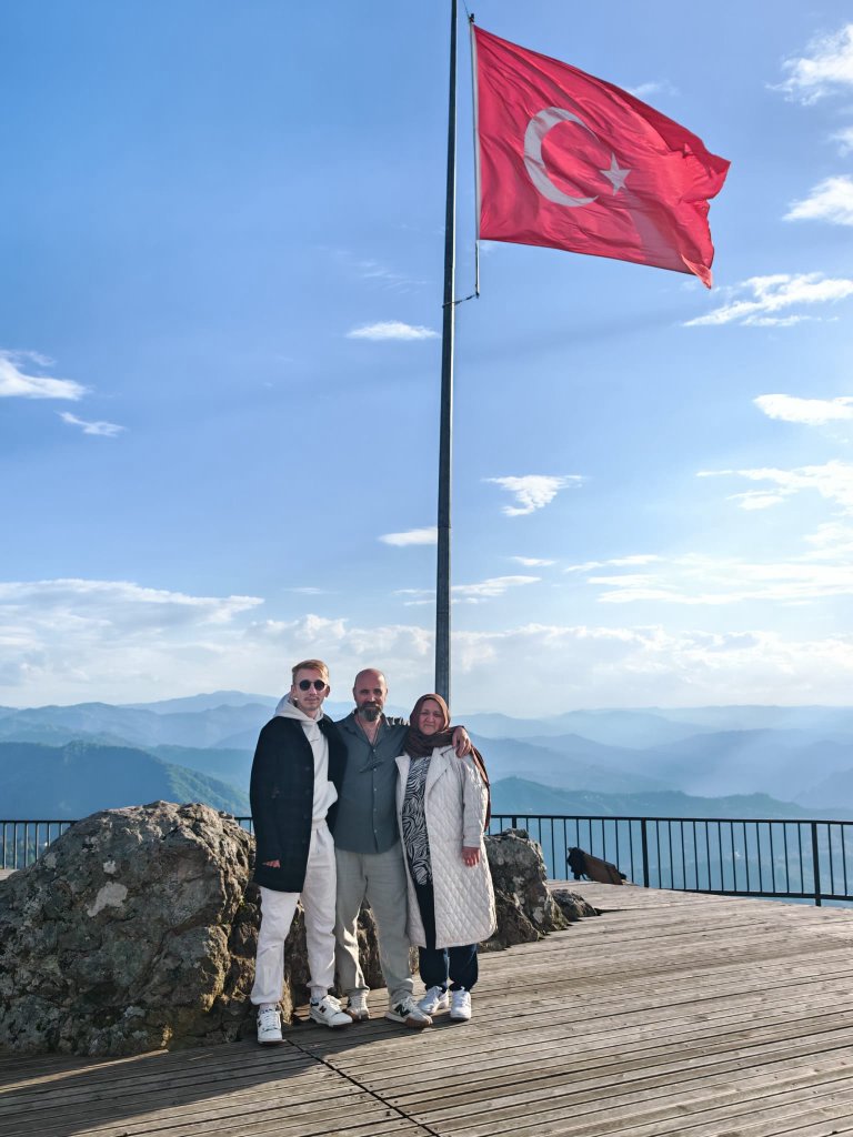 Family at a mountain lookout with Turkish flag