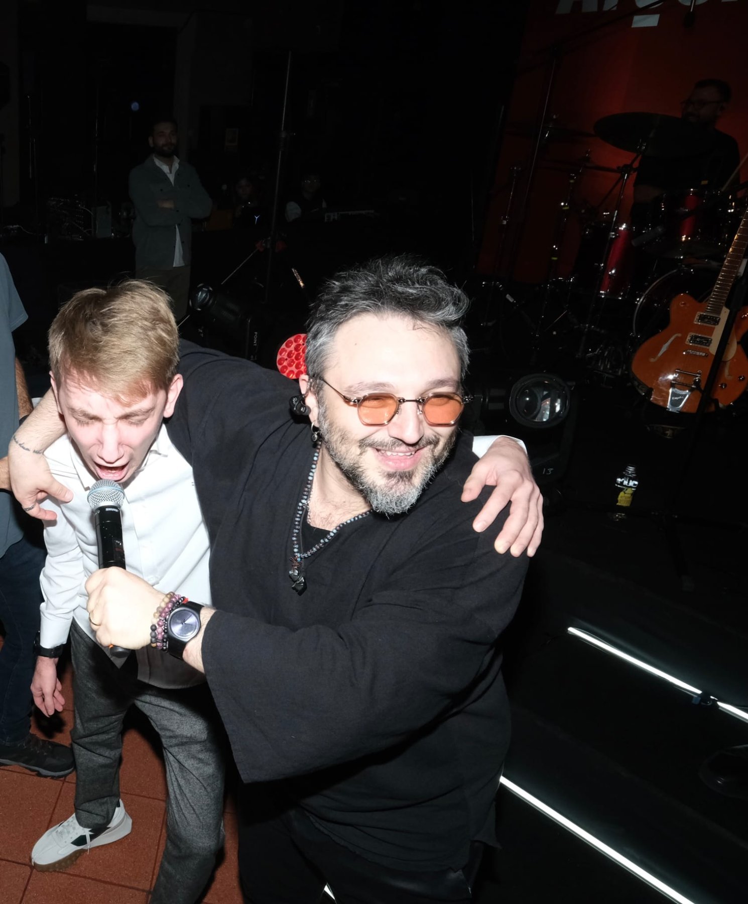 Singing with a friend at a music venue